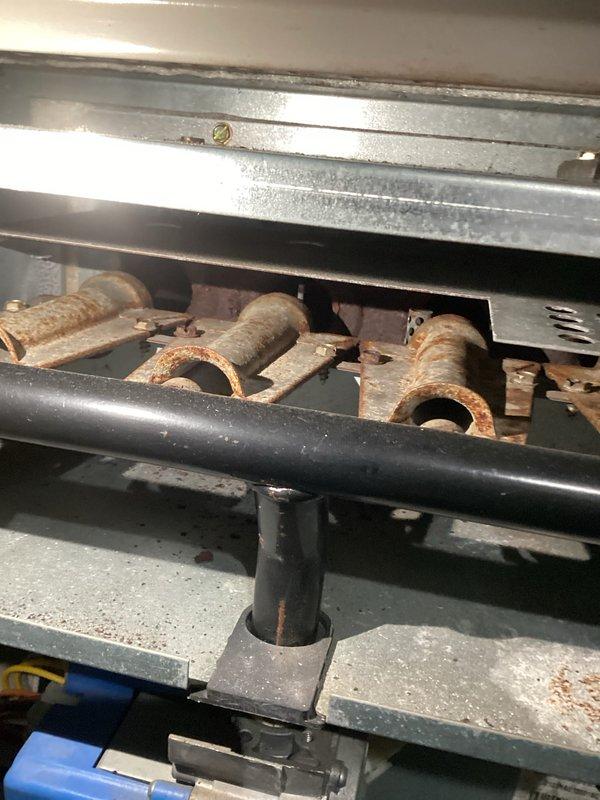 Performed comprehensive tune-up on aging furnace system. Identified significant corrosion and rust accumulation on burner tubes requiring immediate attention. Inspected electrical components, finding disorganized wiring with multiple connection issues that posed potential safety hazards. Cleaned burner assembly, restored proper wire connections, and verified system operation to restore safe functionality.