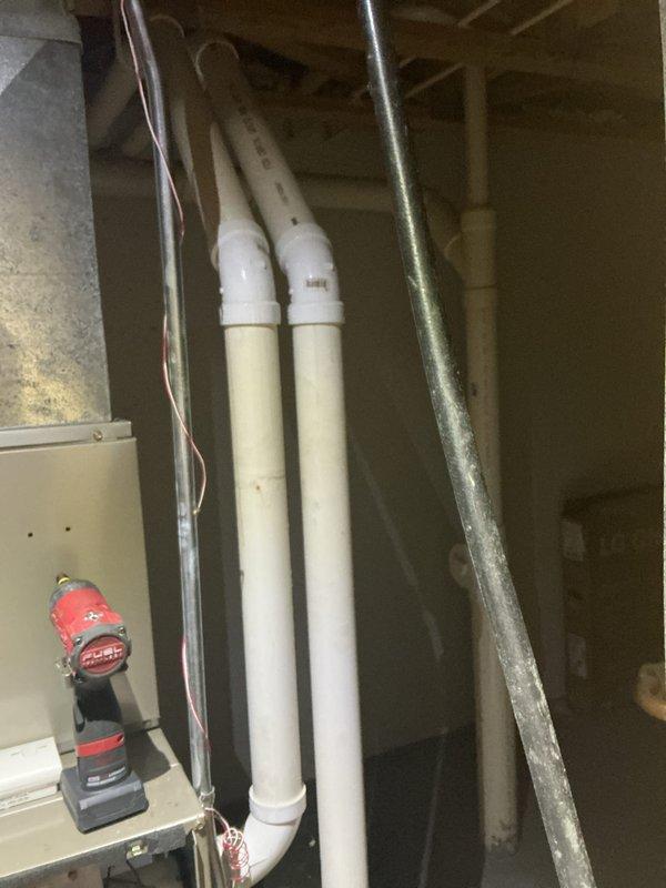 Performed comprehensive tune-up on residential HVAC system, inspecting and servicing both the furnace and associated drainage components. Removed access panel to evaluate internal components including motor, wiring harnesses, and circuit boards. Verified proper operation of PVC drainage/ventilation system in utility area and confirmed all connections were secure.