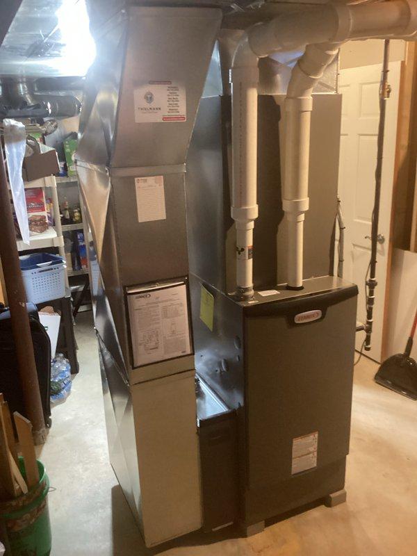 Successfully installed complete residential HVAC system in basement utility room, including furnace unit with proper ductwork connections and PVC ventilation piping. System was properly mounted and secured on concrete floor with all manufacturer specifications followed for optimal performance and efficiency.