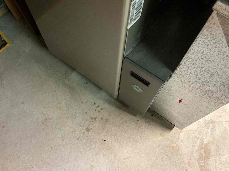 Conducted inspection and documentation of existing HVAC system configuration in utility area, noting current furnace unit placement and adjacent components. Evaluated PVC ventilation piping system, confirming proper SDB 25 specification compliance and structural support integrity. System appears to be installed in corner location with appropriate clearances and connections for replacement consideration.