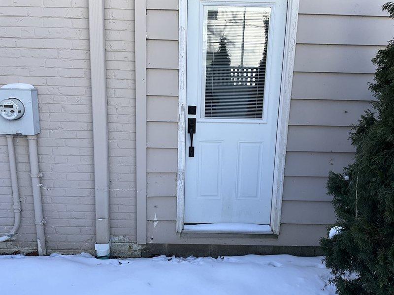 Conducted site assessment for mini split installation in residential basement utility area with existing mechanical systems and exterior access point. Evaluated electrical supply requirements, identified suitable locations for indoor air handler in utility room and outdoor condenser unit near entrance. Documented snow conditions that will require consideration during installation planning.