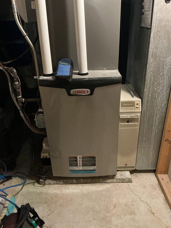 Performed routine tune-up on Lennox HVAC system, inspecting both the furnace unit and associated humidifier/air purifier component. Checked PVC ventilation piping for proper installation and verified drainage system functionality. Conducted visual inspection of ductwork connections and electrical components, confirming all systems are operating within normal parameters.