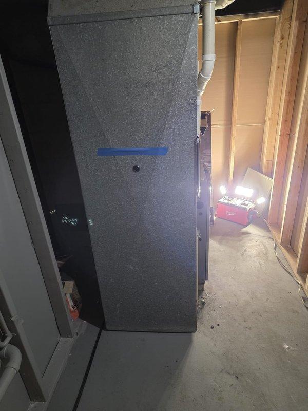 Completed installation of new furnace unit in unfinished basement utility room. System was properly mounted on concrete floor with all necessary drainage and ventilation components connected. Final inspection confirmed proper placement of unit with adequate clearance for service access.