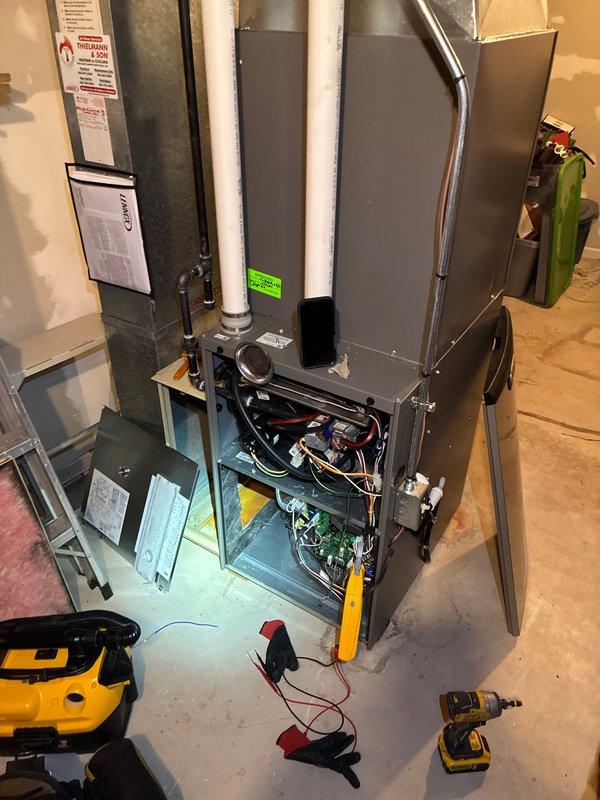 Performed routine tune-up service on residential HVAC system located in basement/utility room. Opened access panels to inspect interior components including circuit boards and wiring connections. Checked for signs of moisture damage and rust in air handler compartment, noting minor discoloration on metal surfaces. All components were found in working order with no major issues requiring repair.