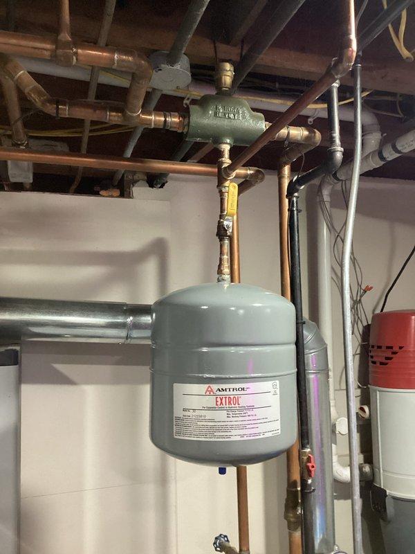 Performed routine service on Buderus boiler system. Inspected Amtrol Extrol expansion tank and associated copper piping network for proper function. Verified all valves and connections were secure with no leaks present throughout the heating system.