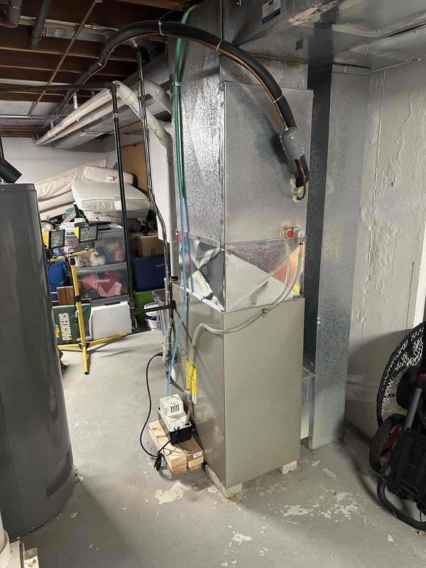 Conducted on-site assessment of existing HVAC system in basement utility area. Existing unit shows signs of wear with exposed components and deteriorating insulation. Recommended full replacement of furnace and associated ductwork with proper insulation to improve efficiency and reliability. Noted need for improved connections to existing refrigerant lines and potential electrical upgrades at connection points.