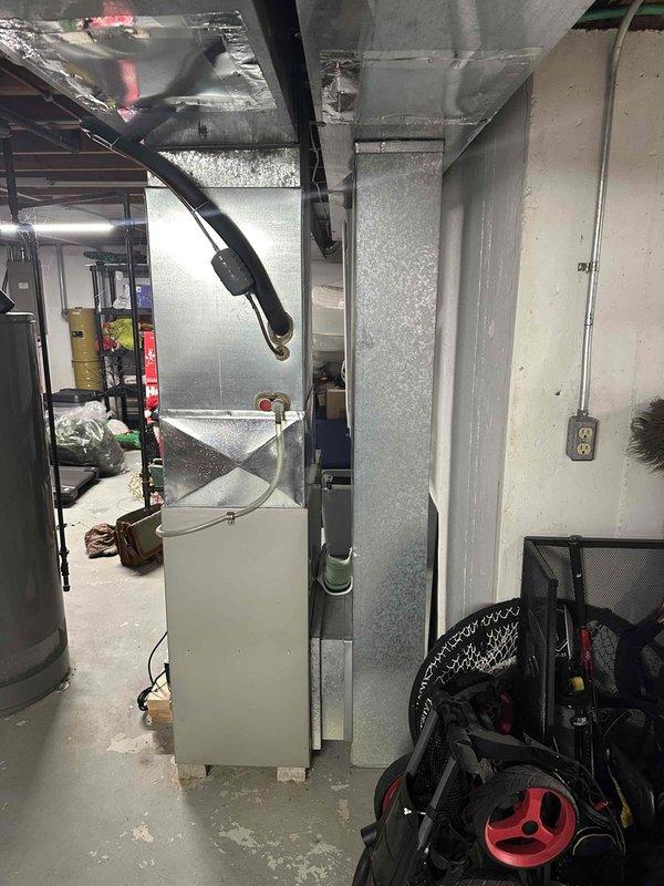 Conducted on-site assessment of existing HVAC system in basement utility area. Existing unit shows signs of wear with exposed components and deteriorating insulation. Recommended full replacement of furnace and associated ductwork with proper insulation to improve efficiency and reliability. Noted need for improved connections to existing refrigerant lines and potential electrical upgrades at connection points.