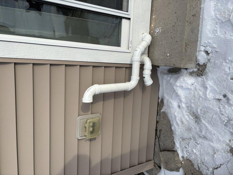 Completed tankless water heater installation with proper venting through exterior wall. Installed PVC condensate drain line with appropriate slope and secured to building exterior. Connected copper supply lines to unit and verified all connections for leaks. System tested and functioning at optimal efficiency with no issues observed.