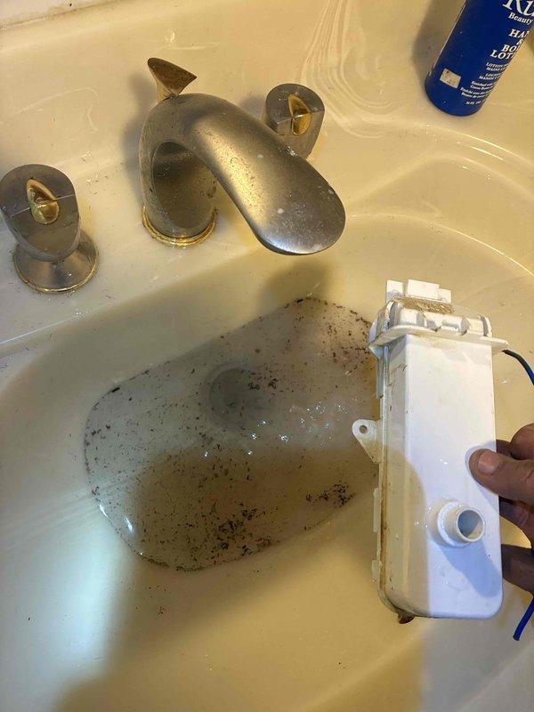 Responded to service call for bathroom plumbing issues. Removed faulty sink fixture and cleaned accumulated residue from basin. Inspected Honeywell Home thermostat which was set to 55 degrees and verified proper operation of heat/cool modes and temperature adjustment functions.