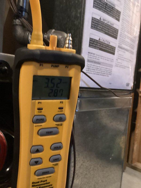 Performed routine HVAC tune-up using dual port manometer to test system pressure readings (352/287), verifying proper operation within manufacturer specifications. Inspected basement ductwork configuration and PVC exhaust/intake piping for integrity and proper installation, confirming all components are functioning correctly with no issues detected.