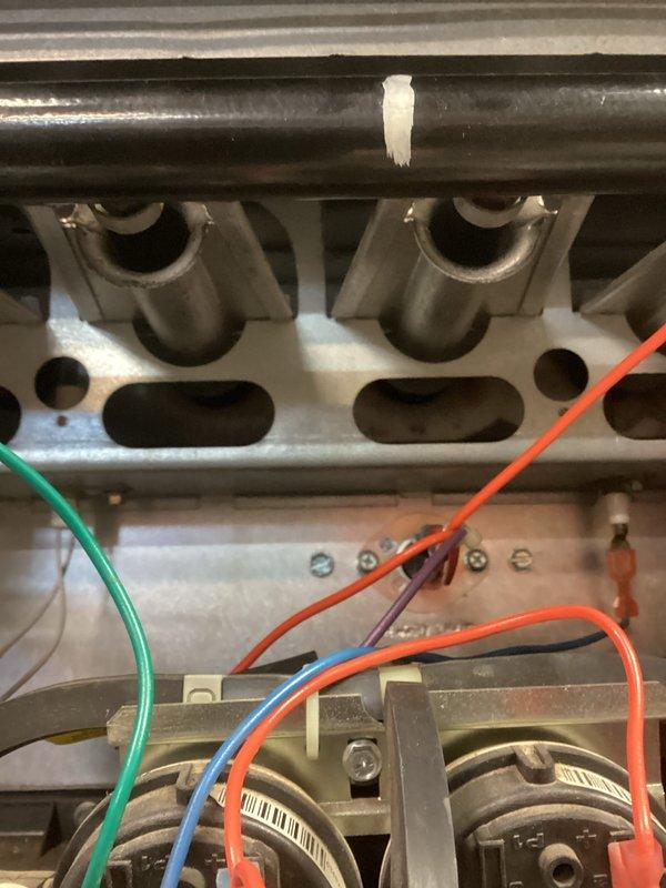 Performed warranty inspection on residential HVAC system. Examined furnace interior components including heat exchanger, burner assembly and control board connections. Verified proper wiring connections to terminals and inspected PVC venting system for proper installation. All components functioning within normal parameters with no operational issues identified.