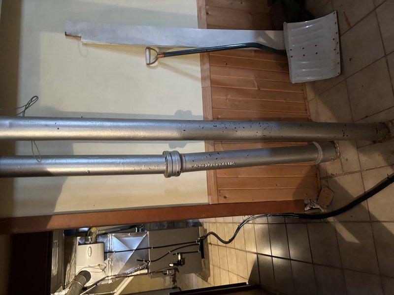 Conducted comprehensive inspection of bathroom shower plumbing system, including examination of chrome shower fixture and water supply lines. Evaluated visible piping infrastructure in utility area, noting proper installation of vertical supply lines with appropriate joints. No immediate issues identified with shower grab bar mounting or tile waterproofing. Recommended routine maintenance of pipe joints to prevent future leakage.