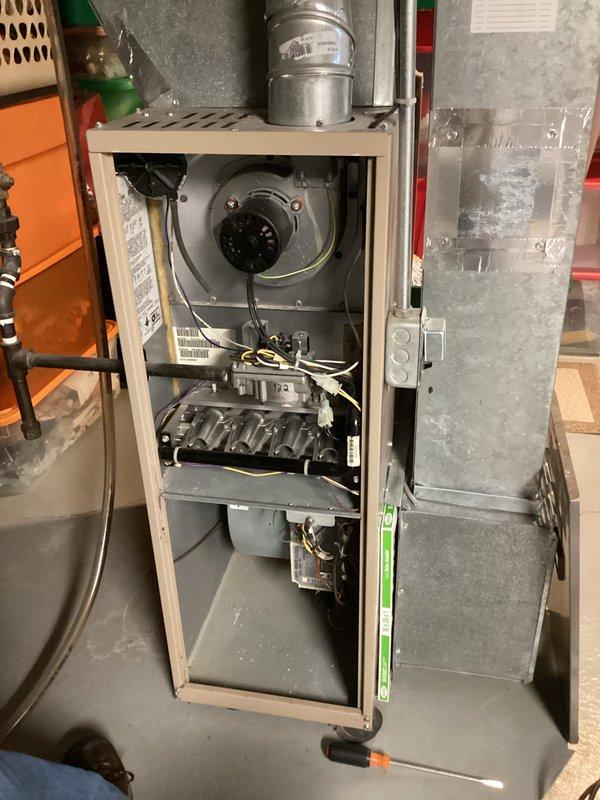 Performed routine maintenance on furnace system under service agreement. Inspected interior components including blower motor assembly, heat exchanger, and electrical connections. Noted dust accumulation on internal components and cleaned affected areas to ensure optimal system performance.