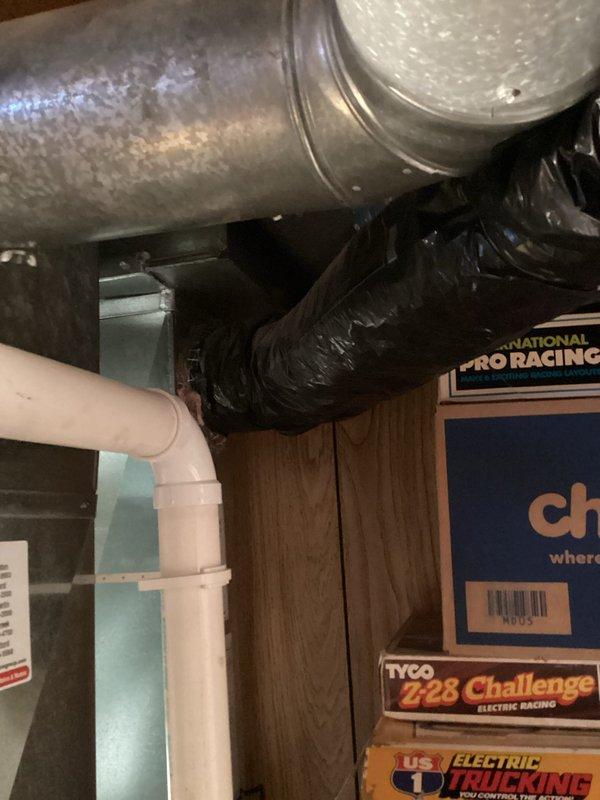 Performed inspection of basement HVAC system, focusing on ductwork configuration. Examined galvanized metal trunk lines, black flexible insulated ducting, and associated PVC drainage components. Verified all connections were properly sealed and insulated with no visible leaks or deterioration. System is functioning as designed with proper airflow throughout.