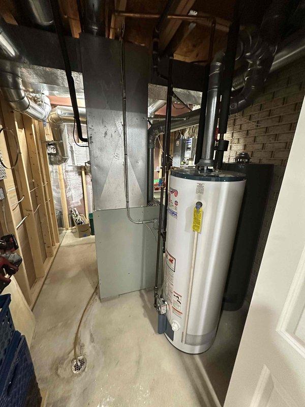 Conducted comprehensive assessment of existing HVAC system located in basement utility room alongside Bradford White water heater. Evaluated current furnace installation, associated ductwork configuration, and available space for replacement unit. Prepared estimate for complete system replacement including proper sizing and connection to existing metal ductwork infrastructure.