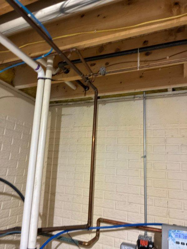Conducted inspection of existing gas line system in unfinished basement area. Evaluated ductwork mounting, support straps, and connection points. Assessed plumbing components including copper pipe configuration, PVC drainage, and PEX tubing installation. Documentation completed with photos showing current system layout for future reference.