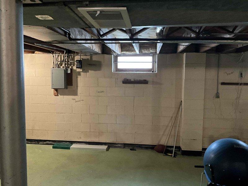 Conducted inspection of existing ductwork system in unfinished basement area. Observed exposed metal ducts running between ceiling joists with visible silver insulation. Evaluated system configuration for potential modifications to accommodate basement repurposing as home gym space while maintaining proper airflow distribution.