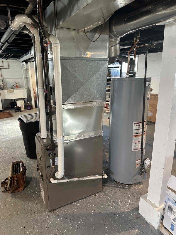 Conducted assessment of existing HVAC system in basement utility room, including Smith water heater and furnace with connected PVC ventilation. System evaluation revealed need for complete replacement of aging equipment. Documented current configuration of ductwork, water connections, and ventilation requirements to prepare comprehensive replacement estimate.