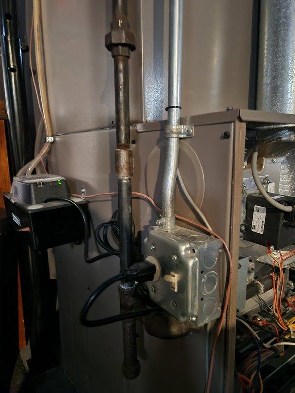 Performed inspection of residential furnace system revealing corrosion on copper piping and potential electrical issues at junction box. Examined blower motor assembly and control module, noting proper operation of fan components. Cleaned corroded connections and verified all wiring was secure with normal system operation restored.