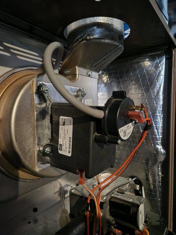 Performed inspection of residential furnace system revealing corrosion on copper piping and potential electrical issues at junction box. Examined blower motor assembly and control module, noting proper operation of fan components. Cleaned corroded connections and verified all wiring was secure with normal system operation restored.