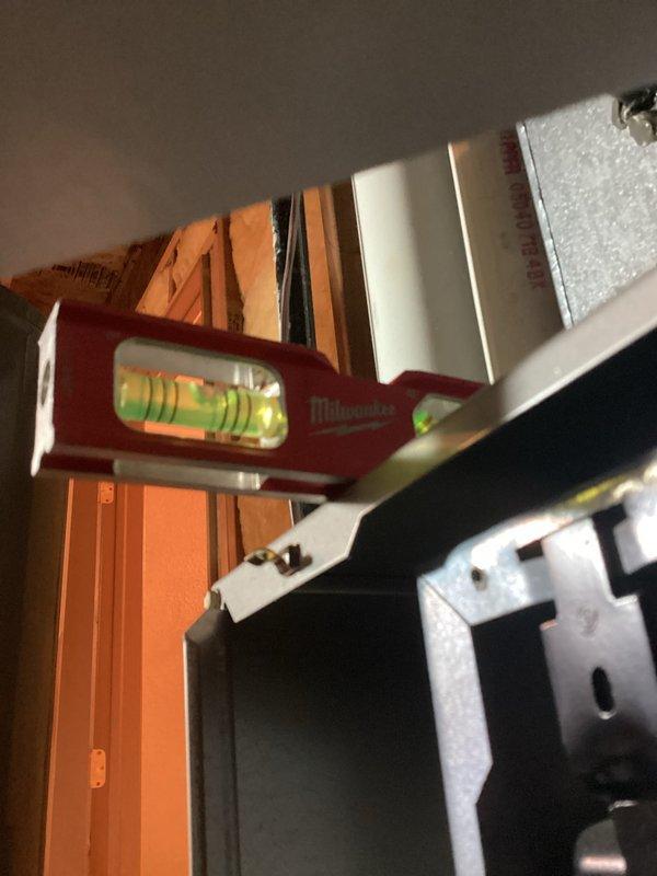 Performed comprehensive HVAC tune-up service including leveling of equipment housing and inspection of internal blower assembly. Verified proper wire connections to control board (red, green, yellow, white) and examined motor condition. System was returned to level operation with all components functioning within normal parameters.