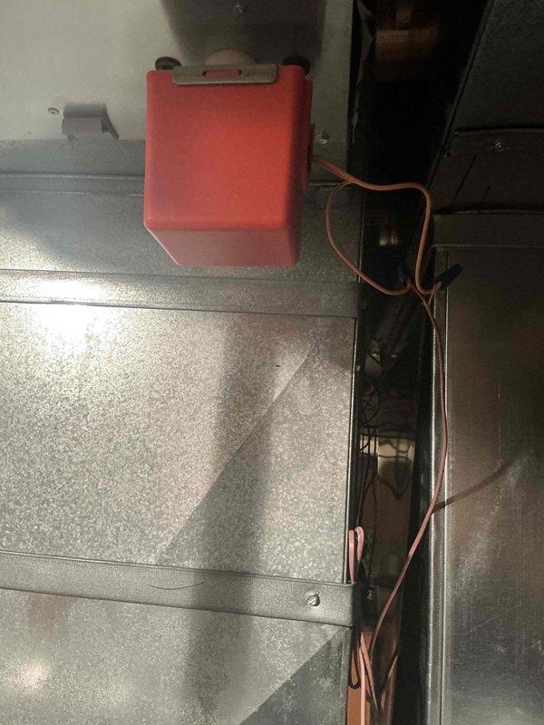 Conducted IAQ assessment on HVAC system, focusing on electrical components and internal ductwork. Identified and documented wiring connections from control interface (red housing unit) to main system. Inspected copper wiring bundle in internal channel for proper routing and potential deterioration. Photos taken of key components for documentation purposes.