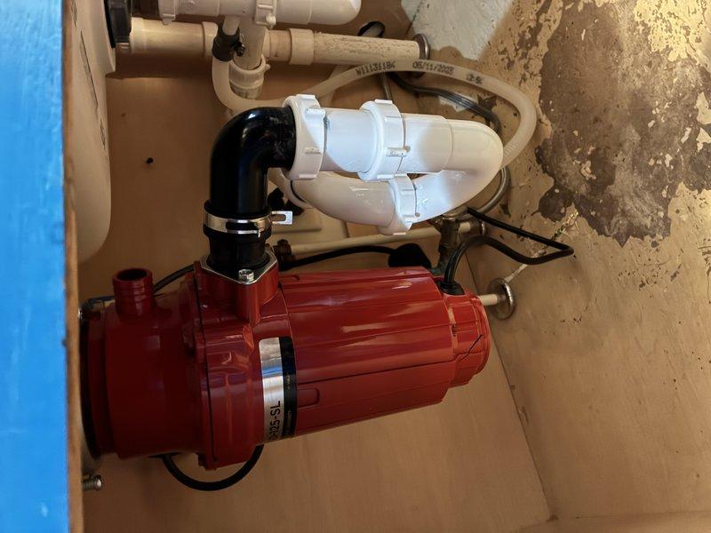 Responded to service call for water leak. Inspected and diagnosed condensation issue at PVC pipe junction where black PVC connects to white PVC piping. Installed new sealing material at the connection point and verified proper operation of the red water pump system with associated drainage components.