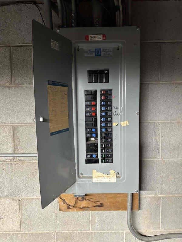 Conducted comprehensive inspection of HVAC system components including examination of wall-mounted thermostat, ventilation outlets, and electrical service panel. Documented existing circuit breaker configuration and evaluated system compatibility for potential replacement. Photos taken of control interfaces and electrical panel for reference in finalizing equipment specifications.