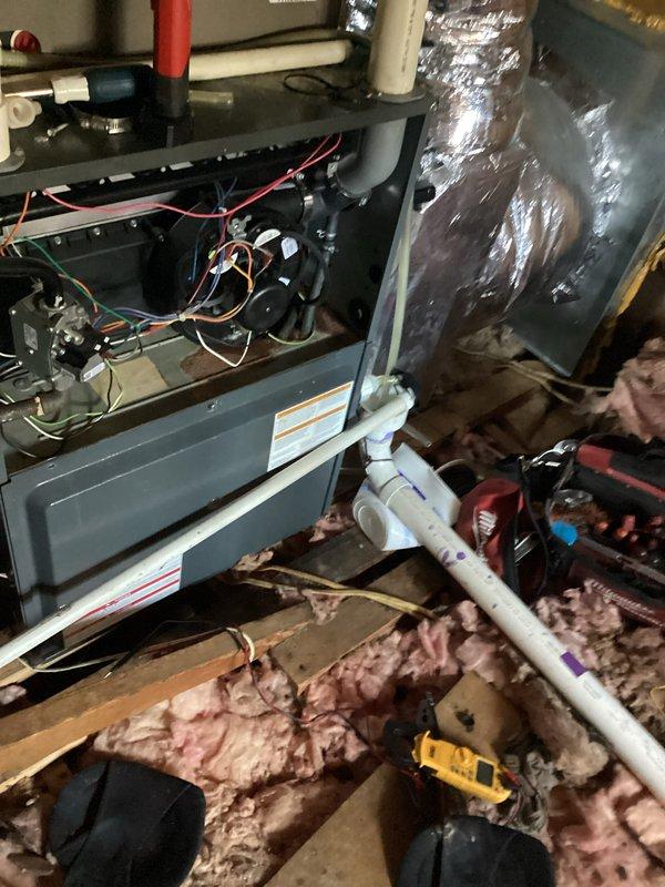 Performed routine tune-up on HVAC system located in attic space. Inspected PVC condensate drain piping and connections for proper installation and function. Examined furnace interior components including electrical connections and wiring. Verified proper installation of PVC exhaust/intake piping with appropriate markings. All components tested and confirmed to be operating within normal parameters.