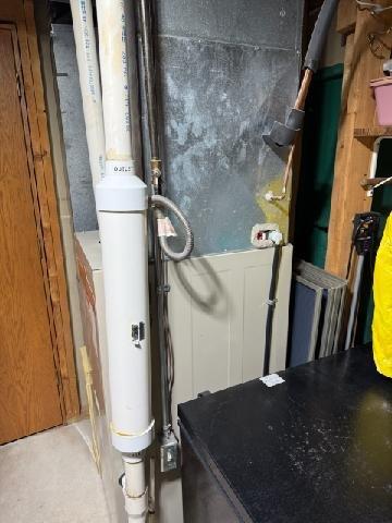 Responded to no-heat call for Ruud furnace system installed in basement. Visual inspection revealed condensate drainage issue in the PVC pipe assembly connected to the furnace. Cleared blockage in condensate line and verified proper drainage. System tested through complete heating cycle with proper operation restored.