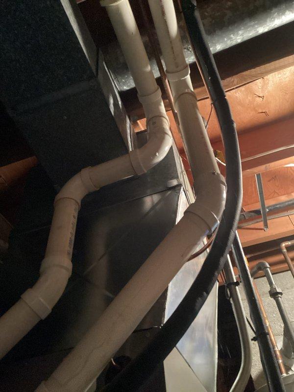 Conducted comprehensive HVAC system tune-up focusing on plumbing infrastructure and system leveling. Inspected PVC pipe network for proper drainage connections and verified equipment level positioning using precision measurement tools. System was confirmed operational with all components properly aligned and secured.