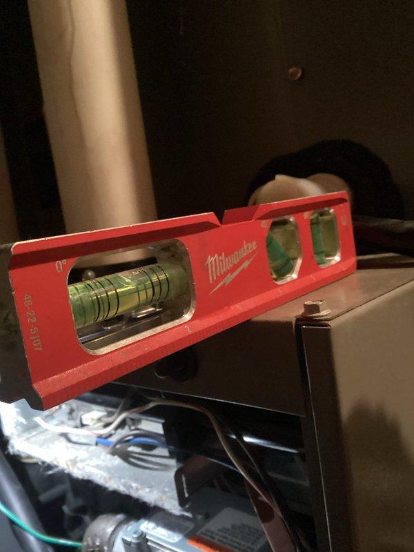 Conducted comprehensive HVAC system tune-up focusing on plumbing infrastructure and system leveling. Inspected PVC pipe network for proper drainage connections and verified equipment level positioning using precision measurement tools. System was confirmed operational with all components properly aligned and secured.