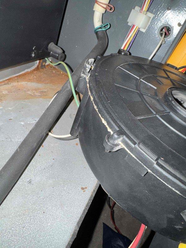 During routine HVAC tune-up, discovered a significant crack in the blower wheel housing that was affecting system performance. Inspected motor assembly and capacitors which showed normal dust accumulation but no electrical issues. Replaced damaged blower wheel assembly to restore proper airflow and system functionality.