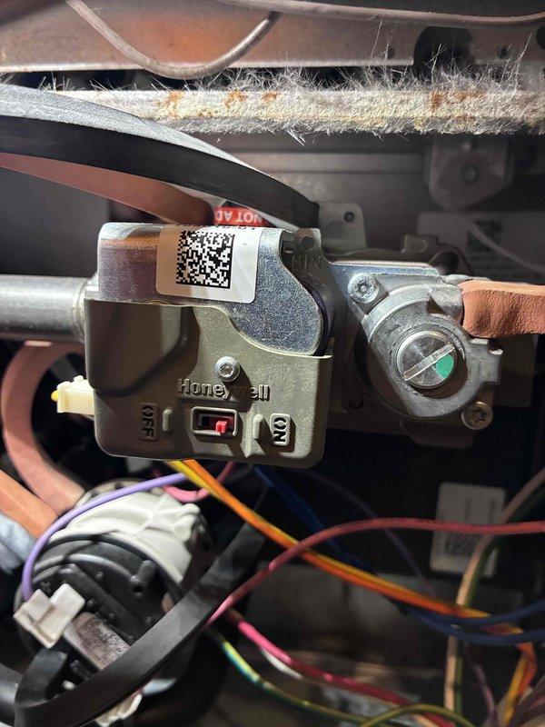 Performed comprehensive HVAC system tune-up including inspection of Honeywell control module. Identified and cleaned significant dust accumulation on components that could affect system efficiency. Conducted electrical diagnostics using clamp meter, confirming low amperage draw of 0.64A, indicating proper electrical operation within manufacturer specifications.