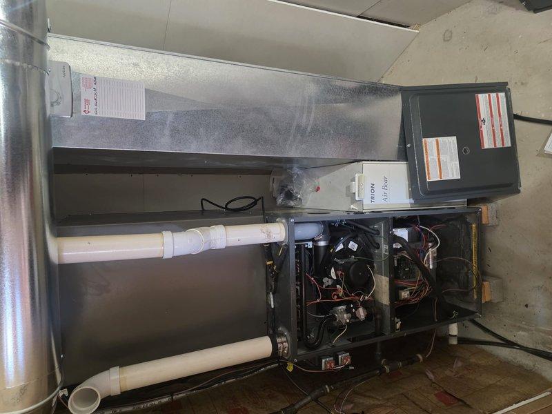 Completed installation of a new HVAC system featuring an air handler with integrated coil and outdoor A/C unit. Installed all necessary PVC drainage and vent lines, connected electrical components, and verified proper operation of the system including the Triton accessory component. Final inspection confirmed all connections secure with no leaks detected.