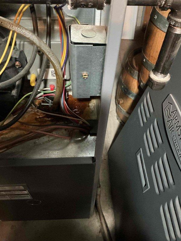 Performed routine tune-up on Armstrong Air HVAC system. Inspected and tested electrical connections (yellow, red, green, and white wiring), checked refrigerant lines, and noted minor condensation at unit base. Interior duct inspection revealed dust accumulation and early signs of oxidation that should be monitored in future maintenance visits.