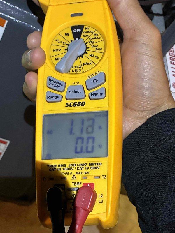 Performed comprehensive HVAC tune-up service including electrical diagnostics using SC680 TRUE RMS multimeter to verify system voltage readings (measured at 1.18V). Conducted refrigerant system inspection with sampling tube to check refrigerant quality and system charge levels.