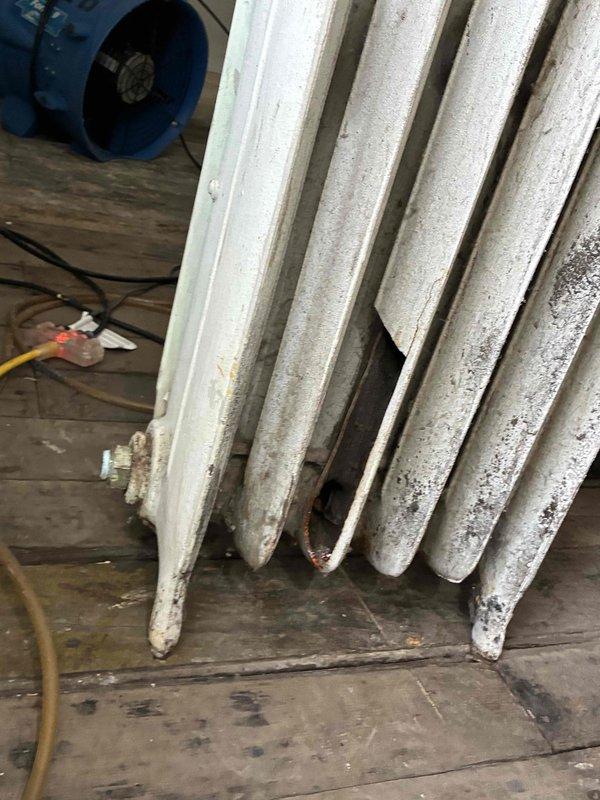 Completed inspection of aging cast iron radiator system showing significant deterioration and dirt accumulation. Examined associated plumbing connections to boiler unit, noting copper pipe discoloration and checking pressure gauge readings. Performed maintenance on valves and regulator components to restore proper system functionality.