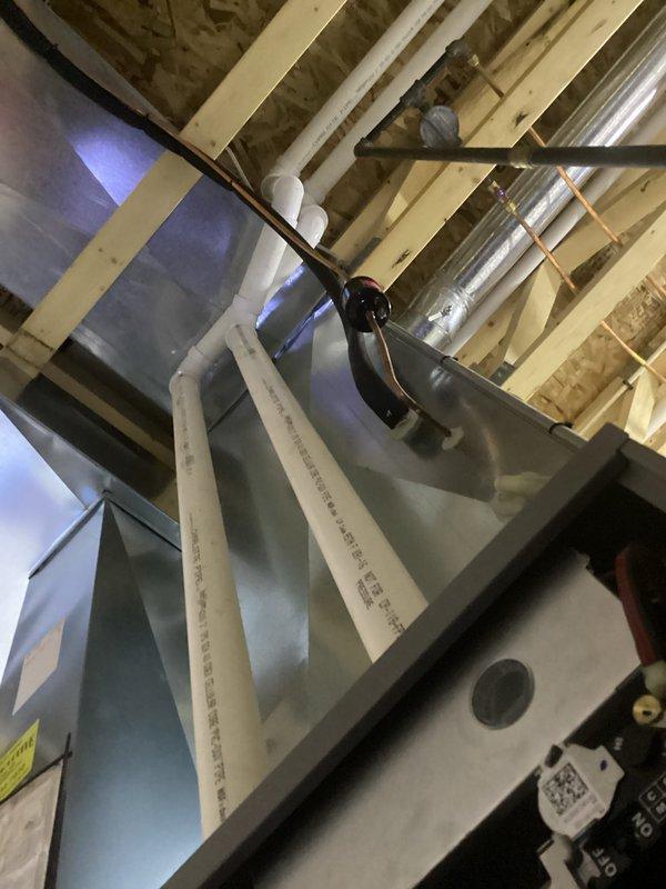 Performed comprehensive HVAC tune-up and inspection of system. Verified level installation of critical components using precision spirit level. Inspected PVC condensate drainage piping and connections to ensure proper installation within the mechanical infrastructure, confirming all components were correctly secured to building framework.