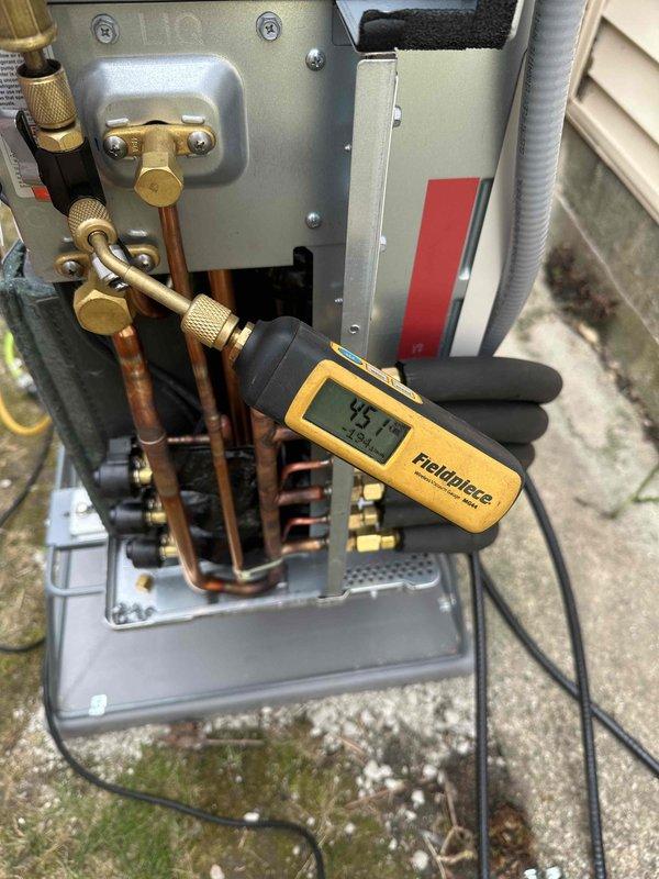 Installed mini-split system with proper pressure testing using Fieldpiece diagnostic tool, confirming system charge at 45.1 PSI. Completed condensate line installation with PVC downspout connection and drainage tubes directed away from building foundation to prevent moisture issues.