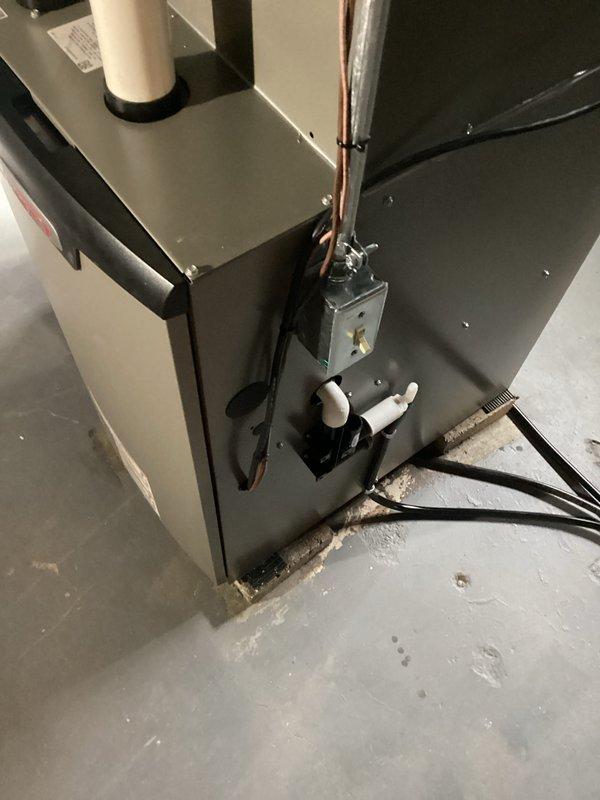 Completed installation of complete HVAC system including primary unit placement in utility area with proper electrical connections and PVC venting. System installation included running dual metallic supply/return lines through existing ductwork with appropriate sealing at junction points.