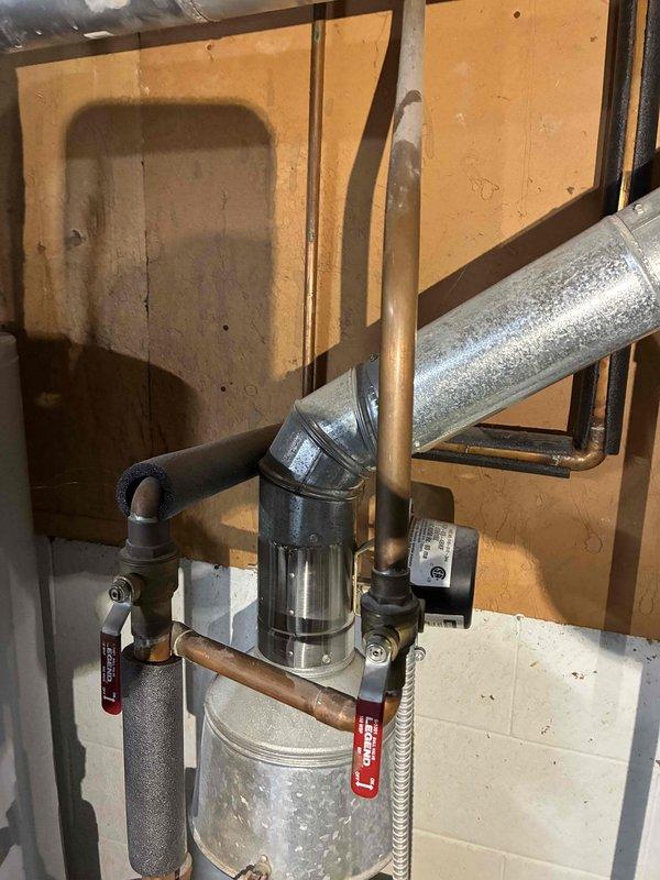 Inspected existing boiler system including horizontal and vertical piping network, insulation condition, and all connected valves. Performed visual assessment of galvanized metal ductwork, copper supply lines, and brass shutoff valve functionality. Verified proper operation of cylindrical heating unit with attached copper pipes of varying diameters, confirming all tagged valves were in correct positions for optimal system performance.