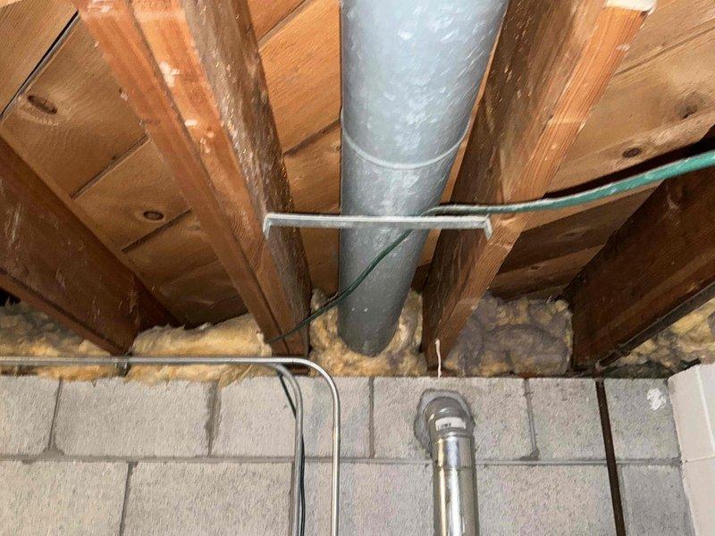 Conducted a comprehensive IAQ (Indoor Air Quality) inspection with photo documentation of the ventilation system. Examined exposed HVAC ductwork in the crawl space, noting the condition of metal duct pipes, hangers, and surrounding insulation. Inspected wall-mounted air register in the kitchen area to evaluate airflow and potential air quality concerns.