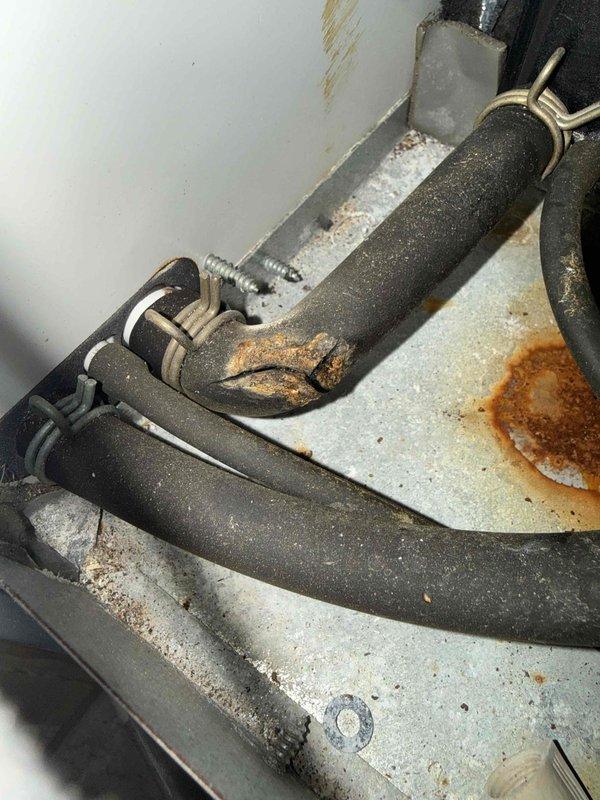 Performed comprehensive tune-up on aging HVAC system, documenting extensive corrosion on condensate drain lines and significant rust formation on the evaporator coil housing. Inspected PVC drain piping connections and identified deteriorating insulation on refrigerant lines that requires attention during next scheduled maintenance.