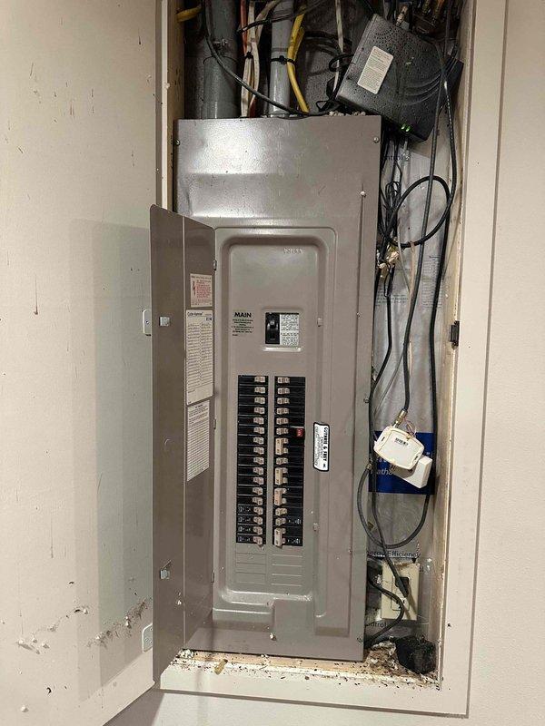 Performed comprehensive inspection of electrical panel and HVAC system in utility room. Evaluated main circuit breaker panel with multiple labeled breakers and examined associated wiring connections. Assessed basement air handler unit with metallic ductwork and PVC piping configuration for potential replacement requirements.