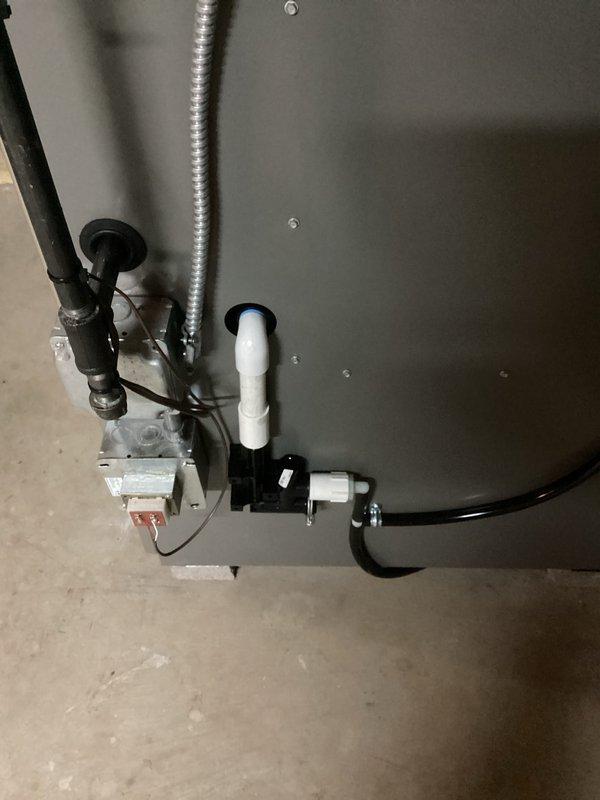 Completed installation of new furnace unit with proper utility connections including gas line, electrical conduit, and PVC venting. System was pressure tested with digital manometer showing 16.5 reading, confirming proper operation. All connections were verified and system is functioning within manufacturer specifications.