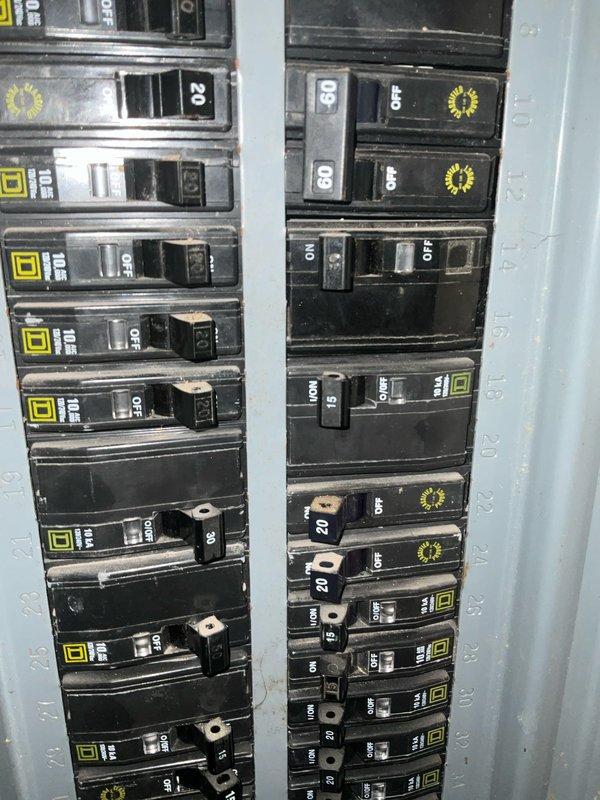 Conducted an inspection of existing mini-split system installed in customer's living area. Observed a wall-mounted indoor air handler positioned above a window. Evaluated the electrical panel to verify adequate capacity for the system, noting various circuit breakers including 15A, 20A, and 50A circuits that would support mini-split operation. System appears to be properly installed with no immediate issues identified.