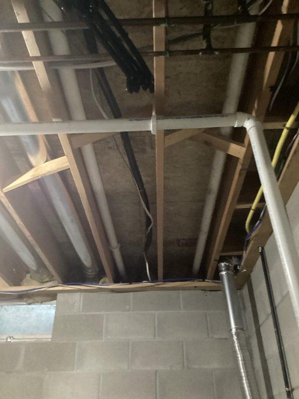 Performed comprehensive tune-up on aging HVAC system located in unfinished basement utility area. Inspected exposed mechanical components including motor assembly, fan housing, and control module, noting oxidation on copper piping and general wear. System remains operational with recommended maintenance schedule established to address aging components.