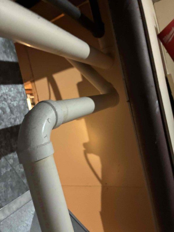 Performed inspection on residential furnace system, examining PVC exhaust/intake piping and interior components. Inspected control board, blower motor assembly, and electrical connections with front access panel removed. System was found to be operating within normal parameters with proper venting configuration.