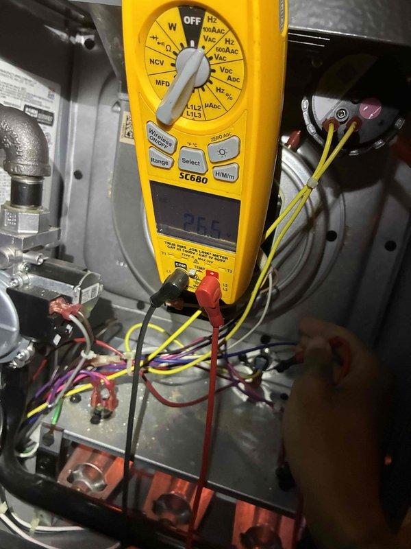 Conducted comprehensive electrical diagnostics on system using Fieldpiece SC660 multimeter. Measured line voltage reading 255V and inspected control board connections. Identified and verified proper wiring terminations at the circuit board, ensuring all connector leads (red, blue, yellow, white) were secure and properly seated.
